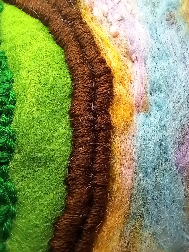 The trapping of foam fruit packaging using brown embroidery thread.